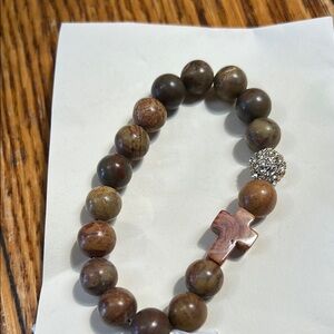 Rosary bead style bracelet on a stretch band.  Cross and crystal bead.